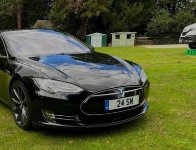 UK Number Plate 24 SN on a 2015 Black Tesla