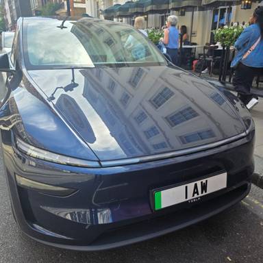 UK Number Plate 1 AW on a 2025 Blue Tesla Model Y Long Range Awd