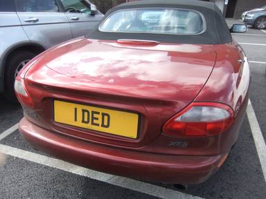 UK Number Plate 1 DED on a 1999 RED Jaguar XK8