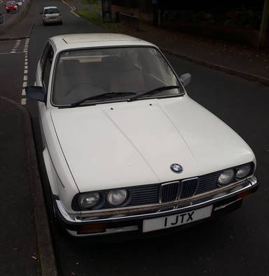 UK Number Plate 1 JTX on a 1986 White BMW 3 Series