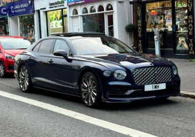 UK Number Plate 1 MH on a 2024 Blue Bentley Flying Spur Mulliner V6 Hyb A