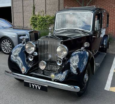 UK Number Plate 1 YYV on a 1938 Black Rolls Royce .