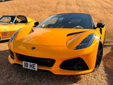 UK Number Plate 18 HE on a 2023 Yellow Lotus Emira V6 First Edition