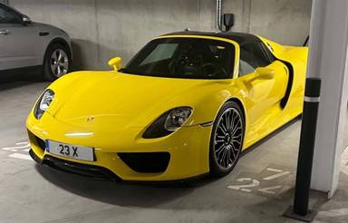 UK Number Plate 23 X on a 2014 Yellow Porsche Spyder S-A