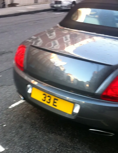 UK Number Plate 33 E on a 2010 Grey Bentley Continental
