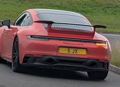 UK Number Plate 5 JX on a 2022 Orange Porsche 911 Carrera 4 Gts