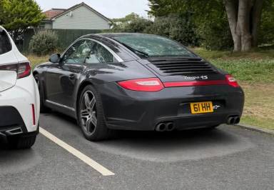 UK Number Plate 61 HH on a 2010 Black Porsche 911