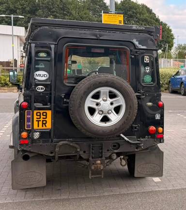 UK Number Plate 99 TR on a 2003 Black Land Rover Defender