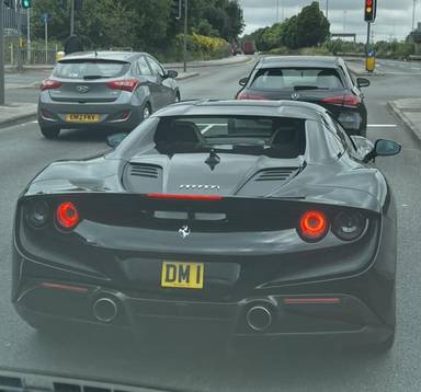 UK Number Plate DM 1 on a 2021 Black Ferrari F8 Spider S-A