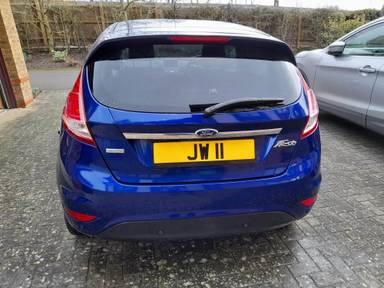 UK Number Plate JW 11 on a 2014 Blue Ford Fiesta