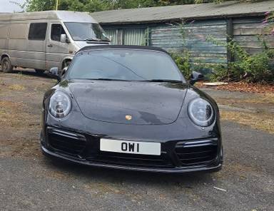 UK Number Plate OW 1 on a Black Porsche 911