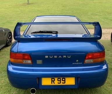 UK Number Plate R 99 on a 1999 Blue Subaru