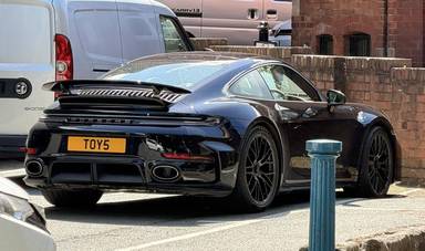 UK Number Plate TOY 5 on a 2026 Black Porsche 911 Turbo S Hev S-A